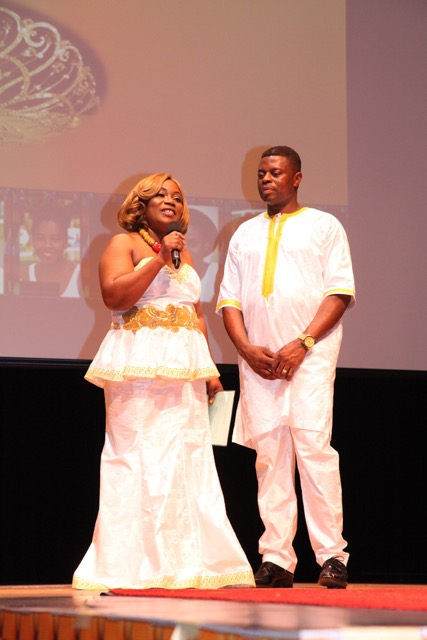 Mr and Mrs Davis on stage dressed in White African attire